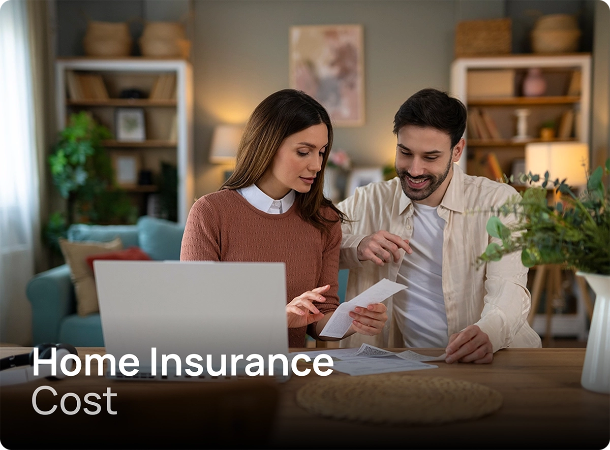 Couple reviewing home insurance costs at home with laptop and documents