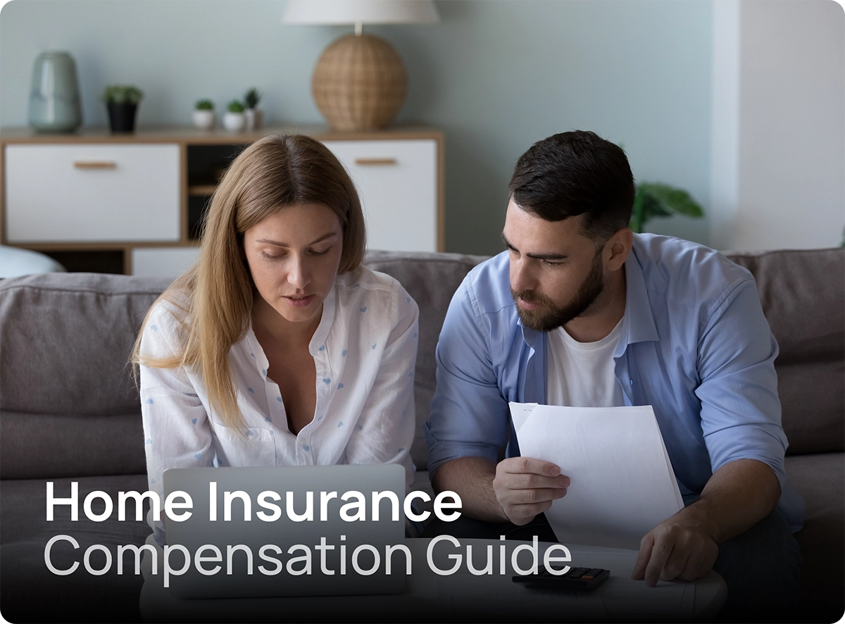 Couple reviewing their home insurance compensation at home with laptop and documents