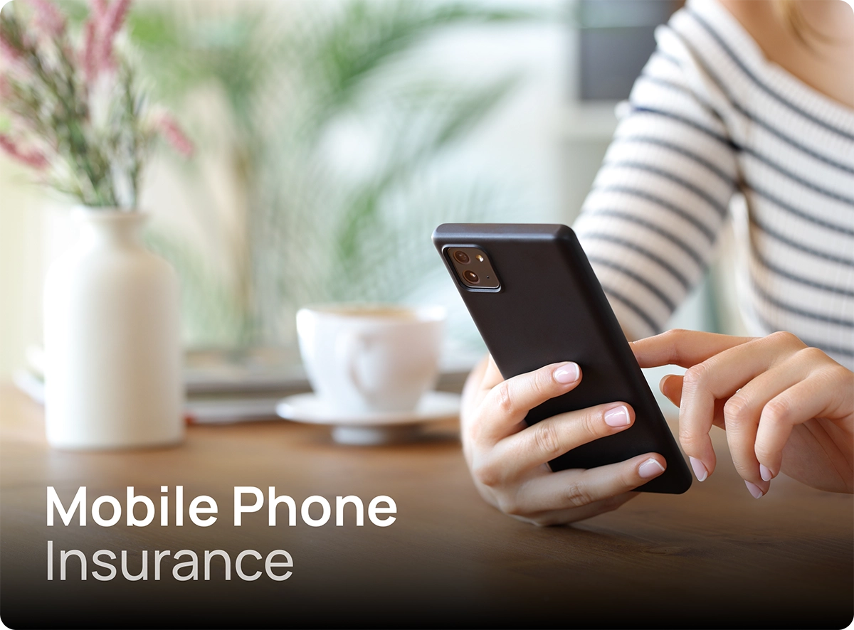 Woman sitting at a kitchen table using her mobile phone.