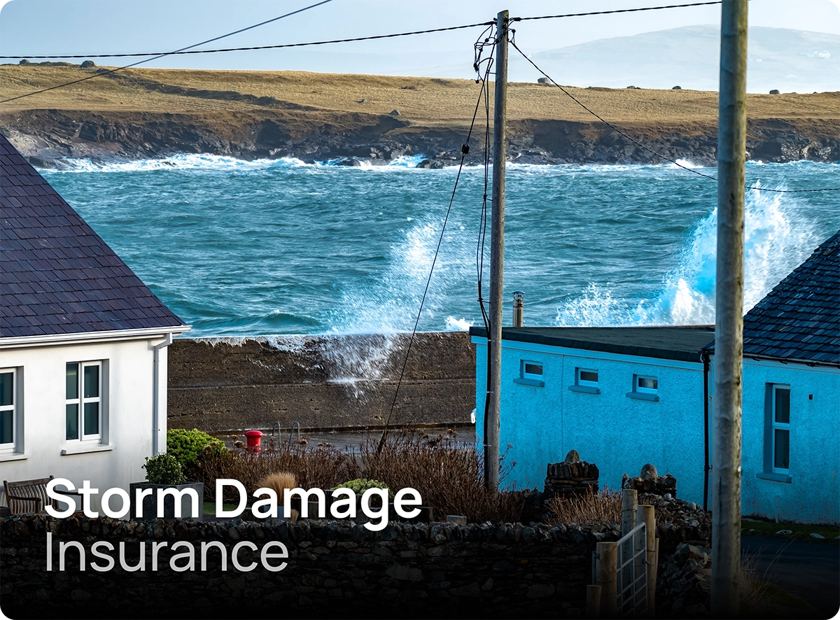 Crashing waves against homes in Donegal during a storm, covered by storm insurance cover